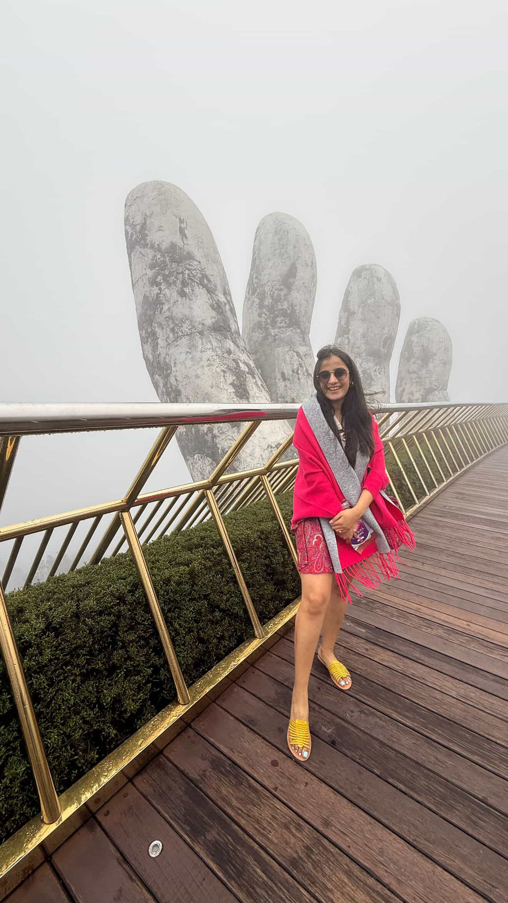 Woman posing on a unique architectural structure with a foggy background