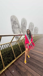Woman posing on a unique architectural structure with a foggy background